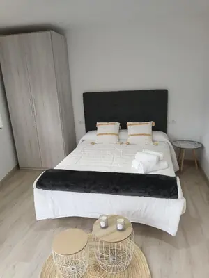 a bedroom with a large bed with two tables at Él Rincón de los Sueños A in Vegadecabo