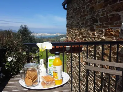 a table with a plate of bread and orange juice at Apartamentos A Palleira in Barreiros