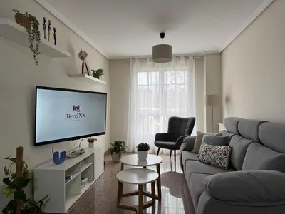 a living room with a couch and a tv at BierzINN Alojamientos - Martina in Ponferrada