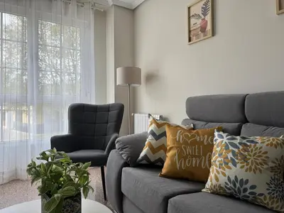 a living room with a couch and a chair at BierzINN Alojamientos - Martina in Ponferrada