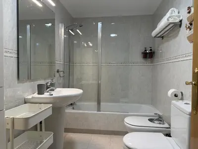a bathroom with a sink and a toilet and a shower at BierzINN Alojamientos - Martina in Ponferrada
