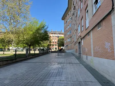 an empty street next to a brick building at BierzINN Alojamientos - Martina in Ponferrada