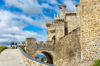 a castle with a stone wall and a bridge at BierzINN Alojamientos - Martina in Ponferrada