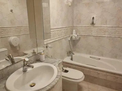 a bathroom with a sink and a toilet and a tub at Pensión Armonía in Caldas de Reis