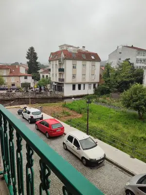 a group of cars parked in a parking lot at Pensión Armonía in Caldas de Reis
