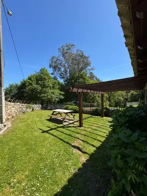a picnic table in a yard with a gazebo at A Palleira in San Amaro