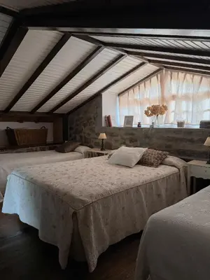 a bedroom with two beds and a window at A Palleira in San Amaro