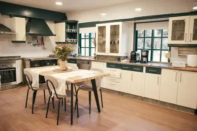a kitchen with a table and chairs in it at Casa Milladoiro in Miño