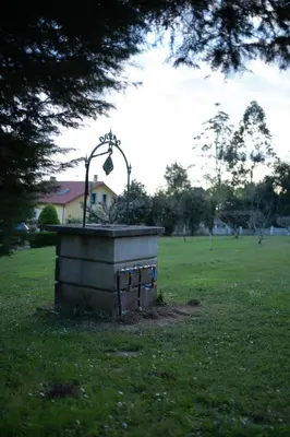 a park with a statue in the grass at Casa Milladoiro in Miño