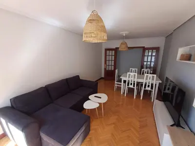 a living room with a couch and a table at Apartamento Camiño de Santiago in Sarria