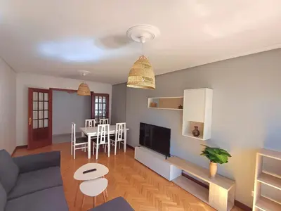 a living room with a couch and a table at Apartamento Camiño de Santiago in Sarria
