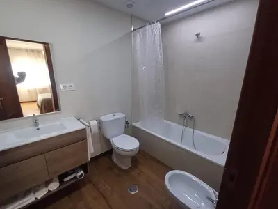 a bathroom with a toilet and a tub and a sink at Apartamento Camiño de Santiago in Sarria