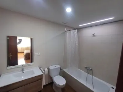 a bathroom with a toilet and a sink and a tub at Apartamento Camiño de Santiago in Sarria