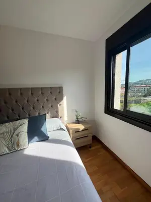 two beds sitting next to each other in a room at Acogedor playa grande Miño in Miño