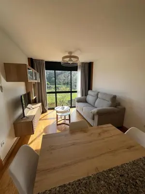 two beds sitting next to each other in a room at Acogedor playa grande Miño in Miño