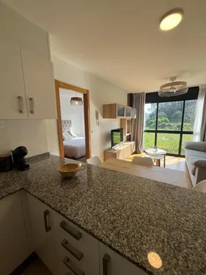 a kitchen with a sink and a microwave at Acogedor playa grande Miño in Miño