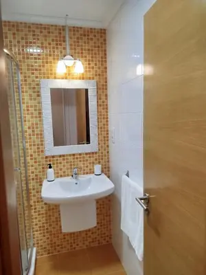 a bathroom with a sink and a mirror at El Valle in San Cosme de Barreiros