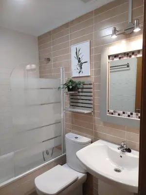 a bathroom with a toilet and a sink at El Valle in San Cosme de Barreiros