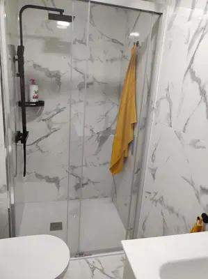 a bathroom with a shower with a yellow towel at Piso en Valadouro in Valle de Oro