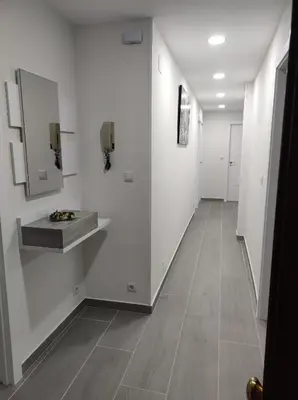 a hallway with white walls and a tile floor at Piso en Valadouro in Valle de Oro