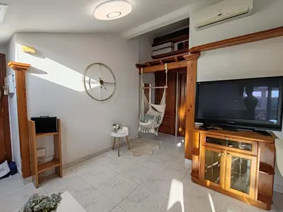a living room with a flat screen tv on a wall at Loft Luxury in Caldas de Reis