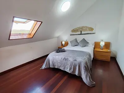 a bedroom with a bed and a window at Loft Luxury in Caldas de Reis