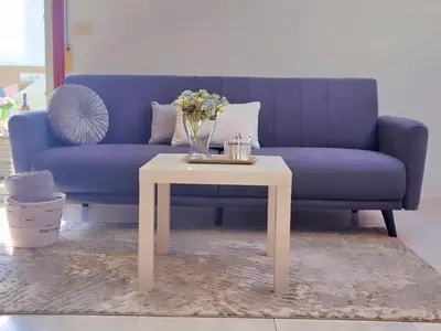 a living room with a blue couch and a table at Loft Luxury in Caldas de Reis