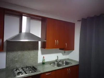 a kitchen with a sink and a stove top oven at Adrian in Arzúa