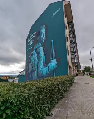 a mural of a man with a gun on the side of a building at Adrian in Arzúa