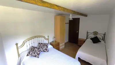 a bedroom with two beds in a room at Casa Aradiña in Santa María