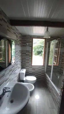 a bathroom with two toilets and a sink at Casa Aradiña in Santa María