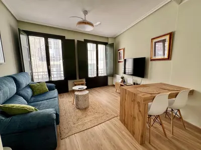 a living room with a blue couch and a table at Bulebule - Acogedor apartamento en pleno centro de Ourense in Ourense