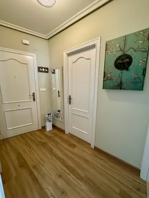 an empty room with a door and a painting on the wall at Bulebule - Acogedor apartamento en pleno centro de Ourense in Ourense