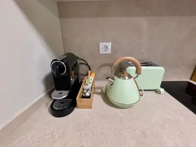 a kitchen counter with a tea kettle and a toaster at Bulebule - Acogedor apartamento en pleno centro de Ourense in Ourense