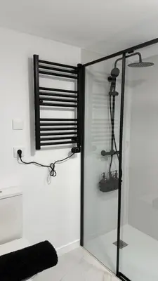 a glass shower in a bathroom with a black at Rua Nova in Sarria