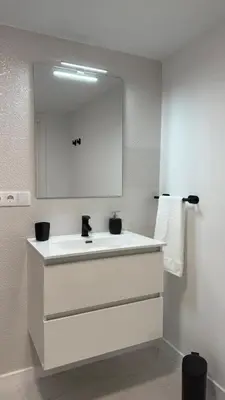 a bathroom with a white sink and a mirror at Rua Nova in Sarria