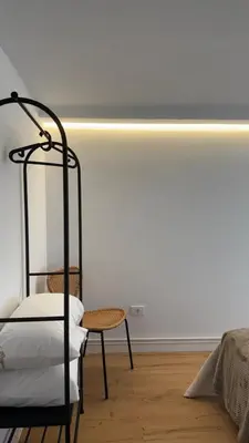 a bedroom with a bed and a table and a chair at Rua Nova in Sarria