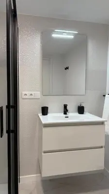 a bathroom with a white sink and a mirror at Rua Nova in Sarria