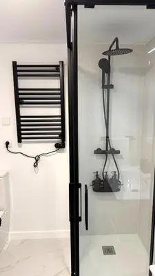 a bathroom with a shower and a glass door at Rua Nova in Sarria