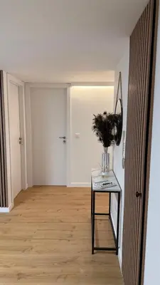 a hallway with a table with a vase on it at Rua Nova in Sarria