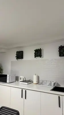 a kitchen with white cabinets and a counter top at Rua Nova in Sarria