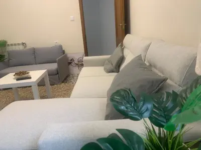 a living room with a white couch and a table at Apartamento en Xinzo de Limia in Xinzo de Limia