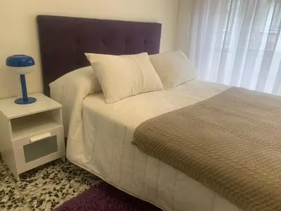 a bedroom with a large bed with a night stand at Apartamento en Xinzo de Limia in Xinzo de Limia