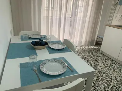 a table with plates and a bowl of grapes on it at Apartamento en Xinzo de Limia in Xinzo de Limia