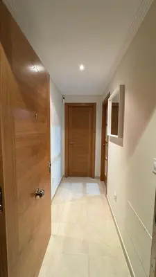 a hallway with a wooden door in a room at Apartamento en Barreiros in San Miguel de Reinante