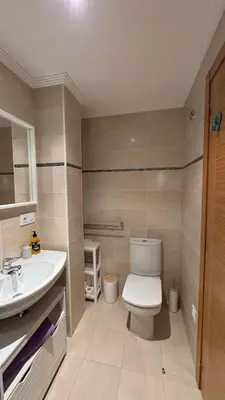 a bathroom with a toilet and a sink at Apartamento en Barreiros in San Miguel de Reinante