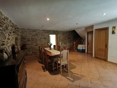 a kitchen and dining room with a table and chairs at Casa Brandelos in Bama