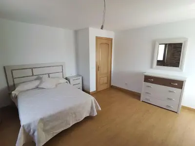 a bedroom with a bed and a dresser and a window at Casa Brandelos in Bama