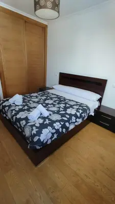 a bedroom with a bed with a black and white comforter at Terra 3A in Caldas de Reis