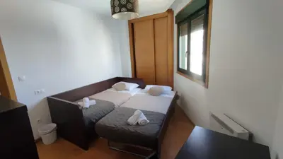 a small room with a bed and a chair at Terra 3A in Caldas de Reis